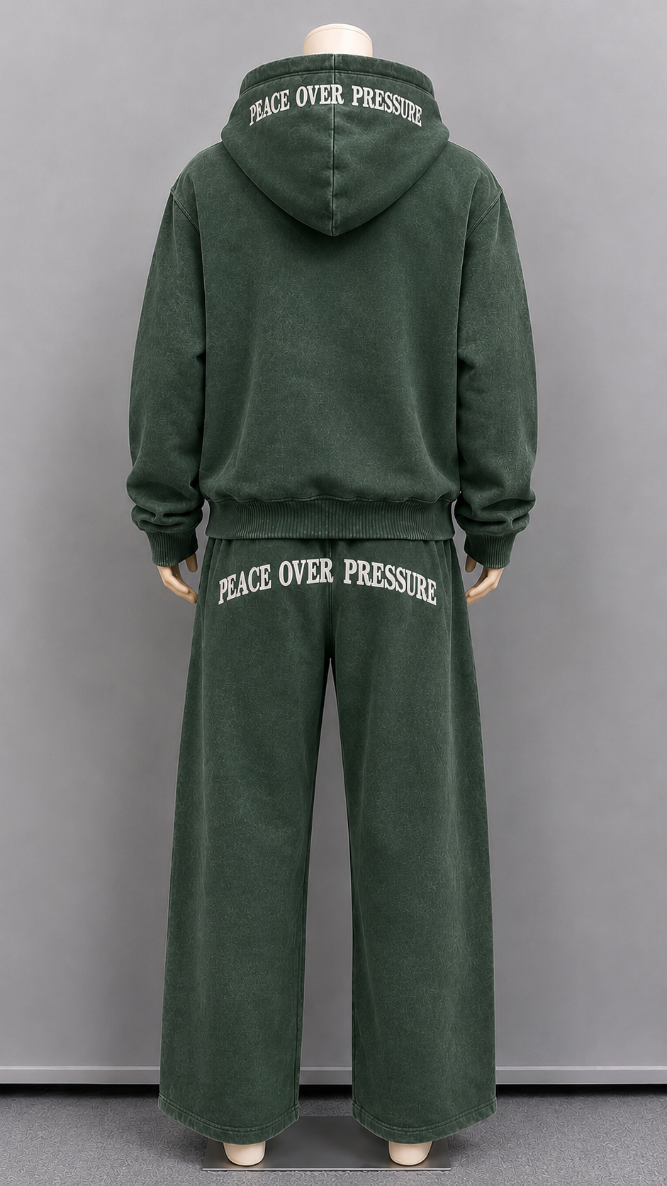 Back of our washed green set featuring "Peace Over Pressure" on both top and bottom.